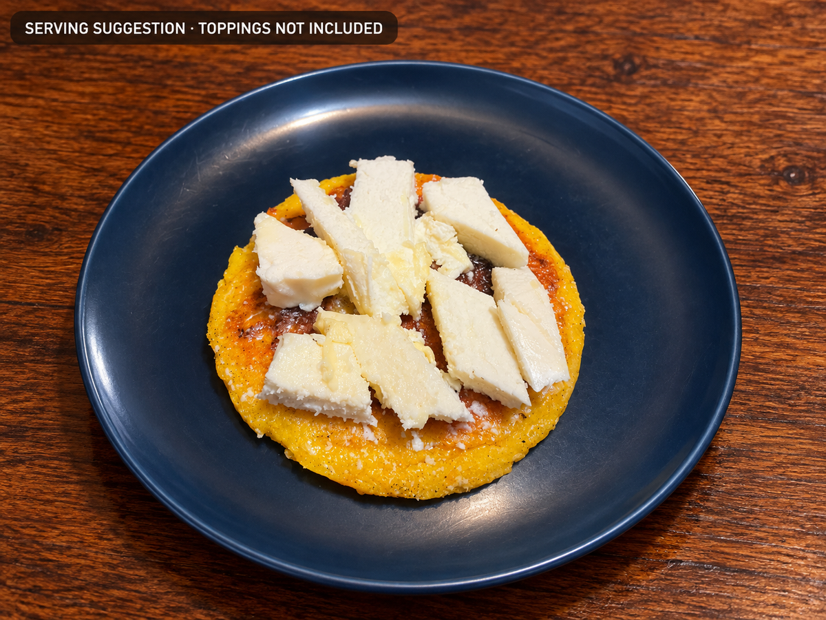 Cooked Chocolo arepa topped with white cheese; serving suggestion, cheese not included.