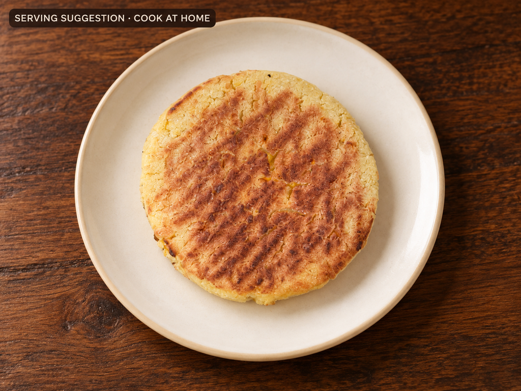 Cooked Chocolo sweet corn arepa on a plate; serving suggestion.
