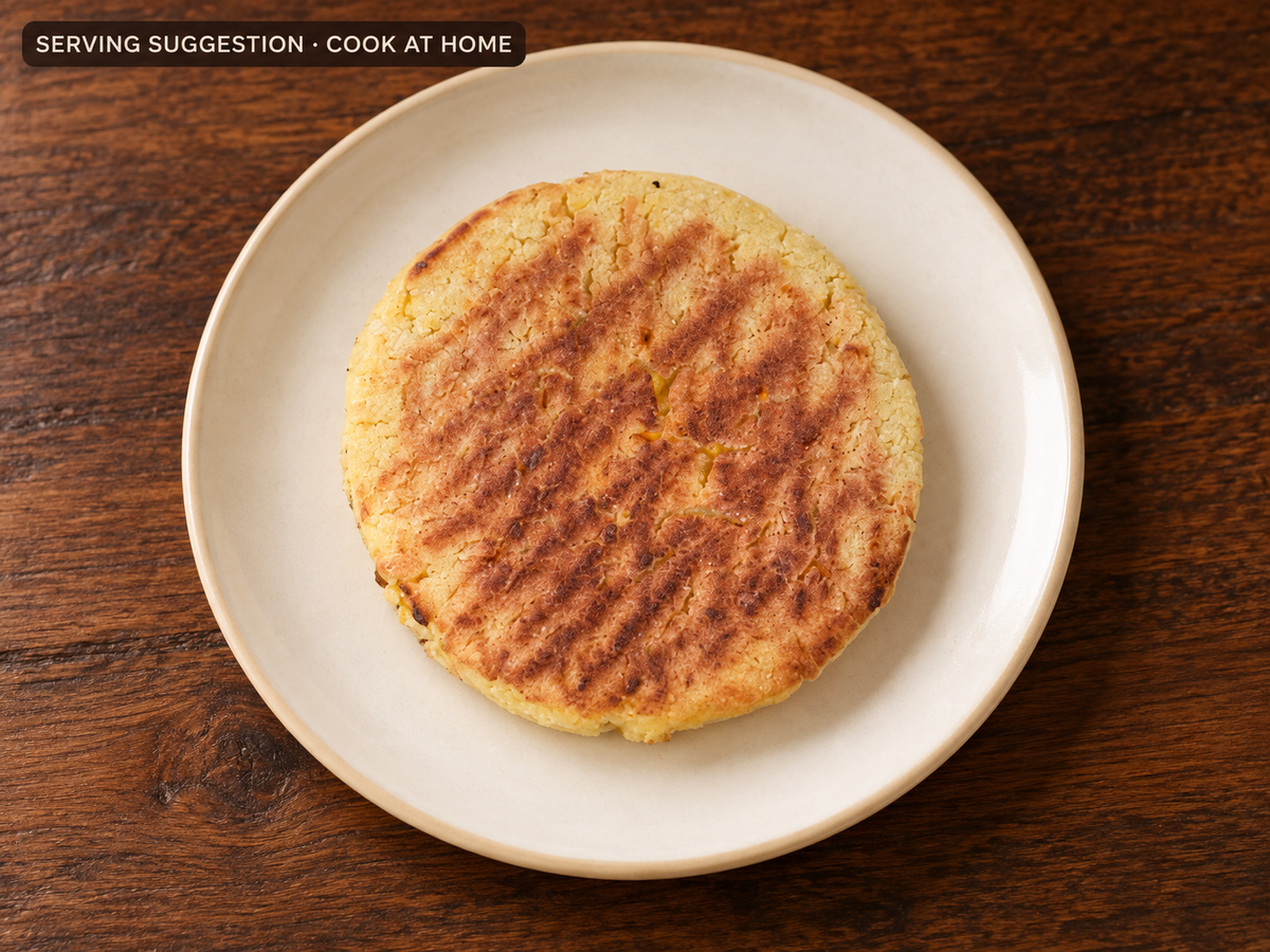 Cooked Chocolo sweet corn arepa on a plate; serving suggestion.
