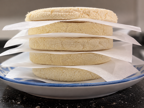 Frozen Classic White Corn arepas showing their thickness and texture.